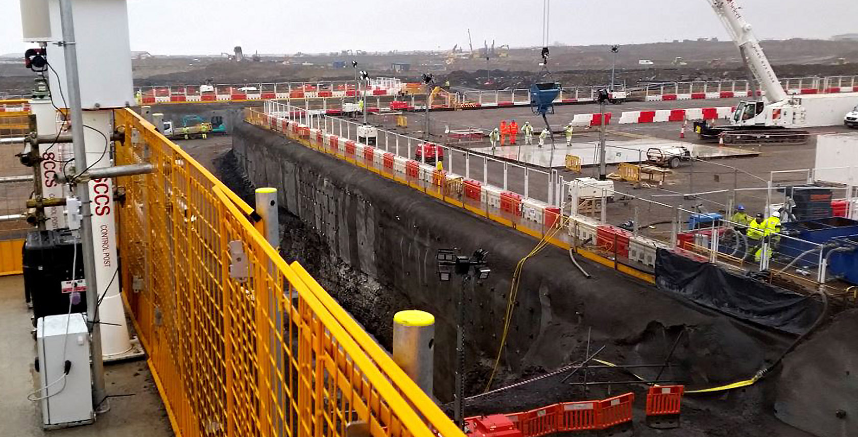 Typical deep excavation into fractured rock held by sprayed concrete facades with rock anchor bolts, monitored by geotechnical instrumentation and arrays of geodetic prisms with an automated TM50 to ensure the safety of workers in and adjacent to deep excavations.